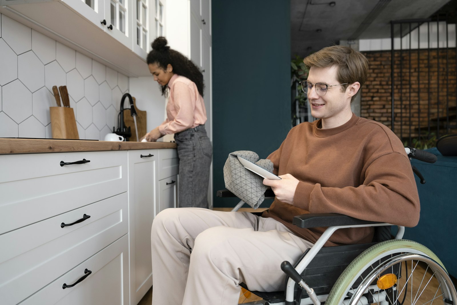 Support worker and a man in a wheelchair in a kitchen